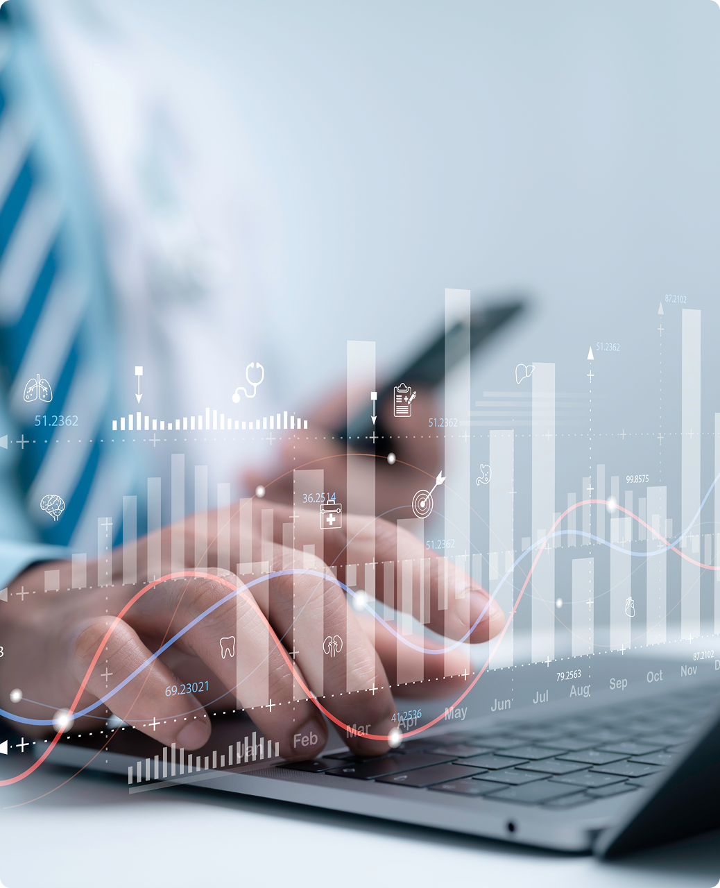 image if a person on a laptop with graphs overlaying their hands