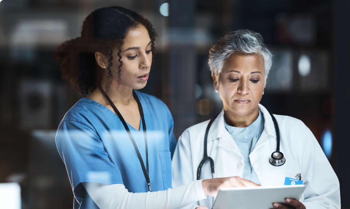 Image of a nurse and a doctor reviewing medical information on a clipboard